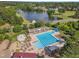 Aerial view of the beautiful community pool near a tranquil lake and lush green golf course at 1326 Fairview Club Dr, Wake Forest, NC 27587