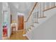 Bright foyer with wood floors, staircase, and elegant details at 1326 Fairview Club Dr, Wake Forest, NC 27587