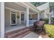 A charming front porch features a brick entry and a cozy covered area at 1326 Fairview Club Dr, Wake Forest, NC 27587