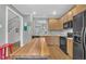 Kitchen with light wooden cabinets, black appliances, view of stairs, and a butcher block island at 1326 Fairview Club Dr, Wake Forest, NC 27587