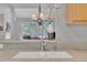 Close up of the kitchen sink with light countertops and a nice decor and view of the dining room at 1326 Fairview Club Dr, Wake Forest, NC 27587