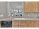 Kitchen sink and countertops in kitchen with tan wooden cabinets and view to dining room area at 1326 Fairview Club Dr, Wake Forest, NC 27587