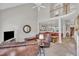 Spacious living room with view of dining room and stairwell, with leather furniture, carpet, and natural light at 1326 Fairview Club Dr, Wake Forest, NC 27587