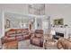 Open concept living room with a fire place, stairwell, and dining room, with leather furniture and carpet at 1326 Fairview Club Dr, Wake Forest, NC 27587