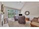 Living room with vaulted ceilings, leather furniture, a fireplace, and glass paneled doors to backyard at 1326 Fairview Club Dr, Wake Forest, NC 27587