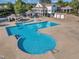 Aerial view of a community pool with a fountain, lounging and wading areas and a clubhouse at 1326 Fairview Club Dr, Wake Forest, NC 27587