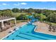 Resort-style pool with a slide, lounge chairs, and a covered patio area at 1326 Fairview Club Dr, Wake Forest, NC 27587