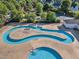 Aerial view of a lazy river pool in a community with surrounding houses and trees at 1326 Fairview Club Dr, Wake Forest, NC 27587