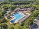 Aerial view of a community pool, which has multiple pools, slides, and seating at 1326 Fairview Club Dr, Wake Forest, NC 27587