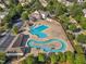 Aerial view of a community pool area with large pool, splash pad, and clubhouse at 1326 Fairview Club Dr, Wake Forest, NC 27587