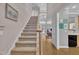 Spacious staircase with carpet and wood accents leading to an open floorplan at 1326 Fairview Club Dr, Wake Forest, NC 27587