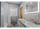 Bathroom featuring double sinks, modern fixtures, decorative tiling, and a shower with curtain at 1603 N Alston Ave, Durham, NC 27701