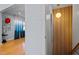 Hallway view featuring modern lighting fixture with wood slat accent wall and an open view to living area at 1603 N Alston Ave, Durham, NC 27701