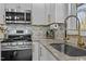 Kitchen featuring stainless appliances, granite countertops, modern fixtures, and custom white cabinetry at 1603 N Alston Ave, Durham, NC 27701