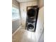 Modern laundry room featuring a stacked washer and dryer unit, with bright white cabinets at 1603 N Alston Ave, Durham, NC 27701