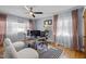 Bright home office featuring a glass desk, modern decor, and soft, natural light from the large window at 1603 N Alston Ave, Durham, NC 27701