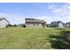 Charming back exterior of the home, featuring a large yard and a covered porch at 172 Fox Run Ct, Benson, NC 27504