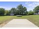 Expansive backyard with lush green grass, a trampoline, and a storage shed at 172 Fox Run Ct, Benson, NC 27504