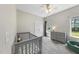 Bedroom with gray crib, dresser and a window with natural light at 172 Fox Run Ct, Benson, NC 27504