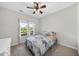 Cozy bedroom with ceiling fan, a window with view and comfortable furnishings at 172 Fox Run Ct, Benson, NC 27504