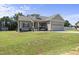 Traditional style home featuring a covered front porch, attached garage, and well-kept lawn at 172 Fox Run Ct, Benson, NC 27504