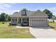 Charming single-Gathering home featuring a two-car garage, covered front porch, and well-maintained lawn at 172 Fox Run Ct, Benson, NC 27504