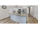 Kitchen featuring white cabinets, a granite-topped island with a sink, and stainless-steel appliances at 172 Fox Run Ct, Benson, NC 27504
