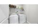Functional laundry room featuring a washer, dryer, and convenient shelving at 172 Fox Run Ct, Benson, NC 27504