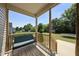 Relaxing porch with a comfortable cushioned bench overlooking the backyard at 172 Fox Run Ct, Benson, NC 27504