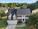 Aerial view of a charming two-story home with a well-maintained lawn and attached two car garage at 1805 Abby Knoll Dr, Apex, NC 27502