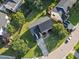 Overhead view of a lovely house showcasing its spacious yard, new roof and landscaping in a neighborhood at 1805 Abby Knoll Dr, Apex, NC 27502