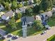 Aerial view of the home in neighborhood with mature trees, well-manicured lawns, and traditional facade at 1805 Abby Knoll Dr, Apex, NC 27502
