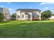 Spacious backyard with a well-maintained lawn, wooden deck, and light colored siding at 1805 Abby Knoll Dr, Apex, NC 27502