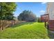 Manicured backyard features a large grassy area and wooden privacy fence at 1805 Abby Knoll Dr, Apex, NC 27502