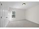 Carpeted bedroom with window and a closet with white doors at 1805 Abby Knoll Dr, Apex, NC 27502