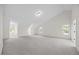 This large bonus room has plush carpeting and several windows for natural light at 1805 Abby Knoll Dr, Apex, NC 27502