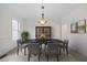 Formal dining room with a large table, chandelier, and elegant wainscoting details at 1805 Abby Knoll Dr, Apex, NC 27502