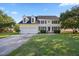Charming two-story home with a well-manicured lawn, attached two-car garage and mature trees under a beautiful sky at 1805 Abby Knoll Dr, Apex, NC 27502