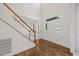 Inviting entryway with wood floors, a staircase with white railings, and a bright front door at 1805 Abby Knoll Dr, Apex, NC 27502
