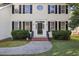 Inviting front entrance with a black front door, sidelights, brick steps and manicured landscaping at 1805 Abby Knoll Dr, Apex, NC 27502
