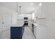 Elegant kitchen features marble countertops, stainless appliances, a navy island, and white cabinets at 1805 Abby Knoll Dr, Apex, NC 27502