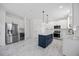Bright kitchen features a center island with marble counters, white cabinets, and stainless appliances at 1805 Abby Knoll Dr, Apex, NC 27502