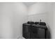 Clean laundry room with modern front-load washer and dryer, tile floors, and a wire shelf for storage at 1805 Abby Knoll Dr, Apex, NC 27502