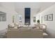 Bright living room with vaulted ceilings, a modern fireplace with blue accents, and neutral furnishings at 1805 Abby Knoll Dr, Apex, NC 27502
