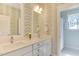 Charming bathroom with wallpaper, a double vanity with white marble countertops, and stylish fixtures at 1830 Wilshire Ave, Raleigh, NC 27608