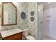 Bathroom featuring a glass shower and designer wallpaper at 1830 Wilshire Ave, Raleigh, NC 27608