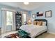 Light-filled bedroom with a bed, decor, and large windows bringing in plenty of natural light at 1830 Wilshire Ave, Raleigh, NC 27608