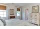Bright bedroom featuring two windows and a dresser with a doorway to the bathroom at 1830 Wilshire Ave, Raleigh, NC 27608