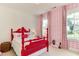 Vibrant bedroom with a bright red bed and complementary patterned wallpaper and curtains at 1830 Wilshire Ave, Raleigh, NC 27608