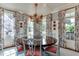 Bright dining room with large round table, stylish chairs, and decorative floral patterned curtains at 1830 Wilshire Ave, Raleigh, NC 27608